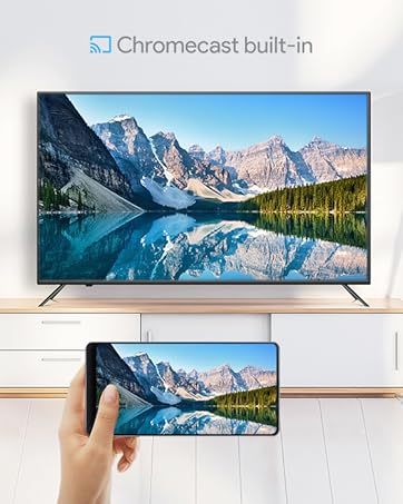 a person holding a smart phone in their hand and a tv showing a landscape