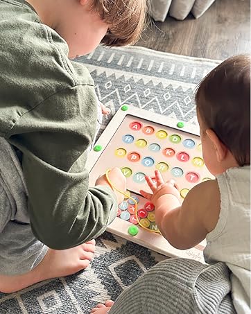 Siblings playing together with Quiggly Magnetic Alphabet Maze