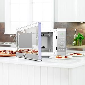 stainless steel microwave, partly open, with slices of pizza on plates arranged around it