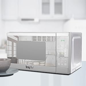 Total Chef stainless steel microwave with a gray bowl and plate on a white background