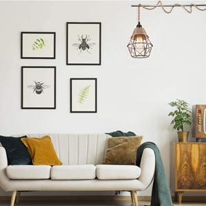 a white sofa with a yellow and green throw pillows and a wooden table.