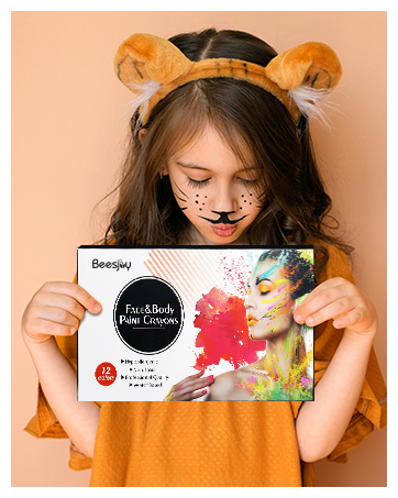 a girl holding a face mask with a tiger face paint on it.