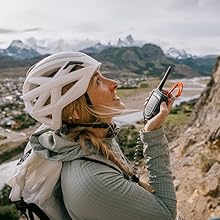 Woman climbing using Rocky Talkie radio to communicate with partner